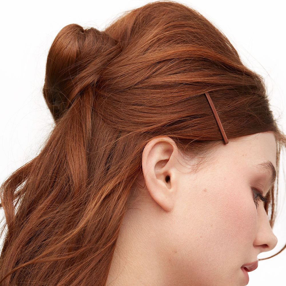 Crimson pins in hair